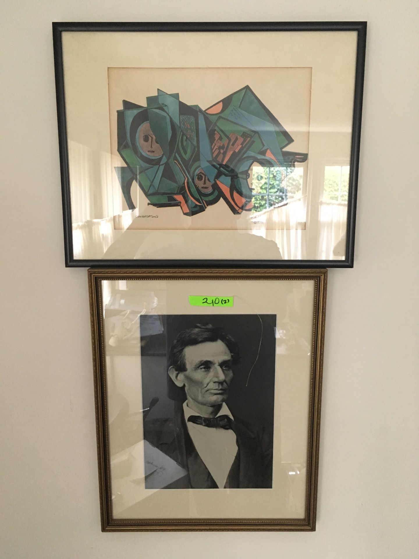 Two pieces of framed artwork one is an abstract image that is signed and