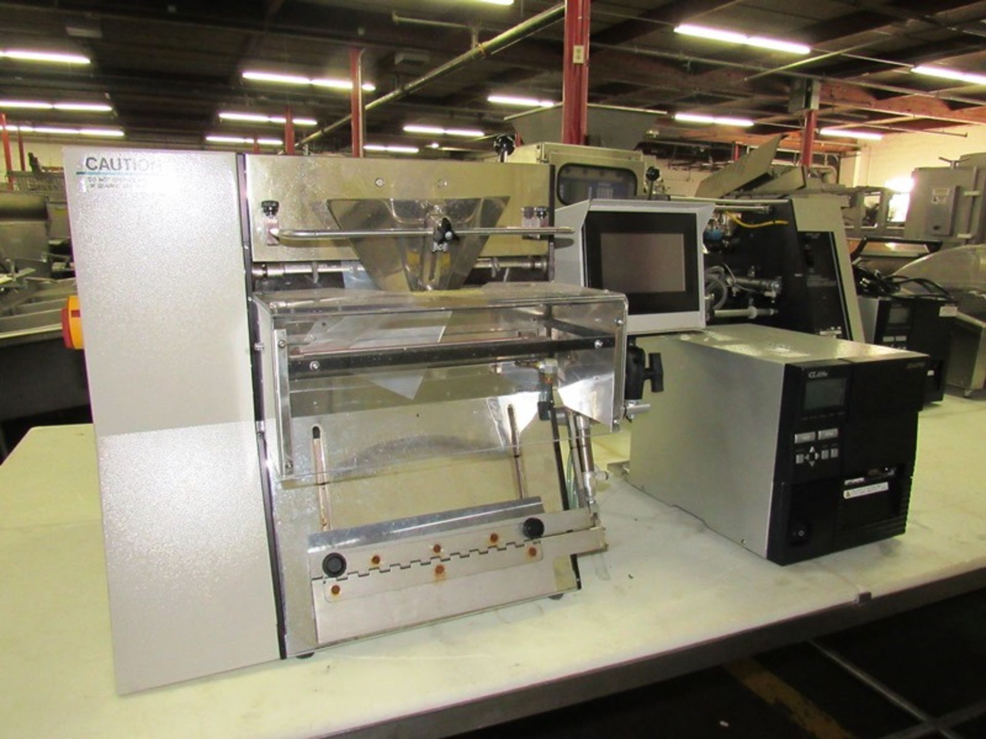 Advance Poly Packaging Inc. Mdl. T-300 Automatic Table Top Bagger with touch screen operation, bag