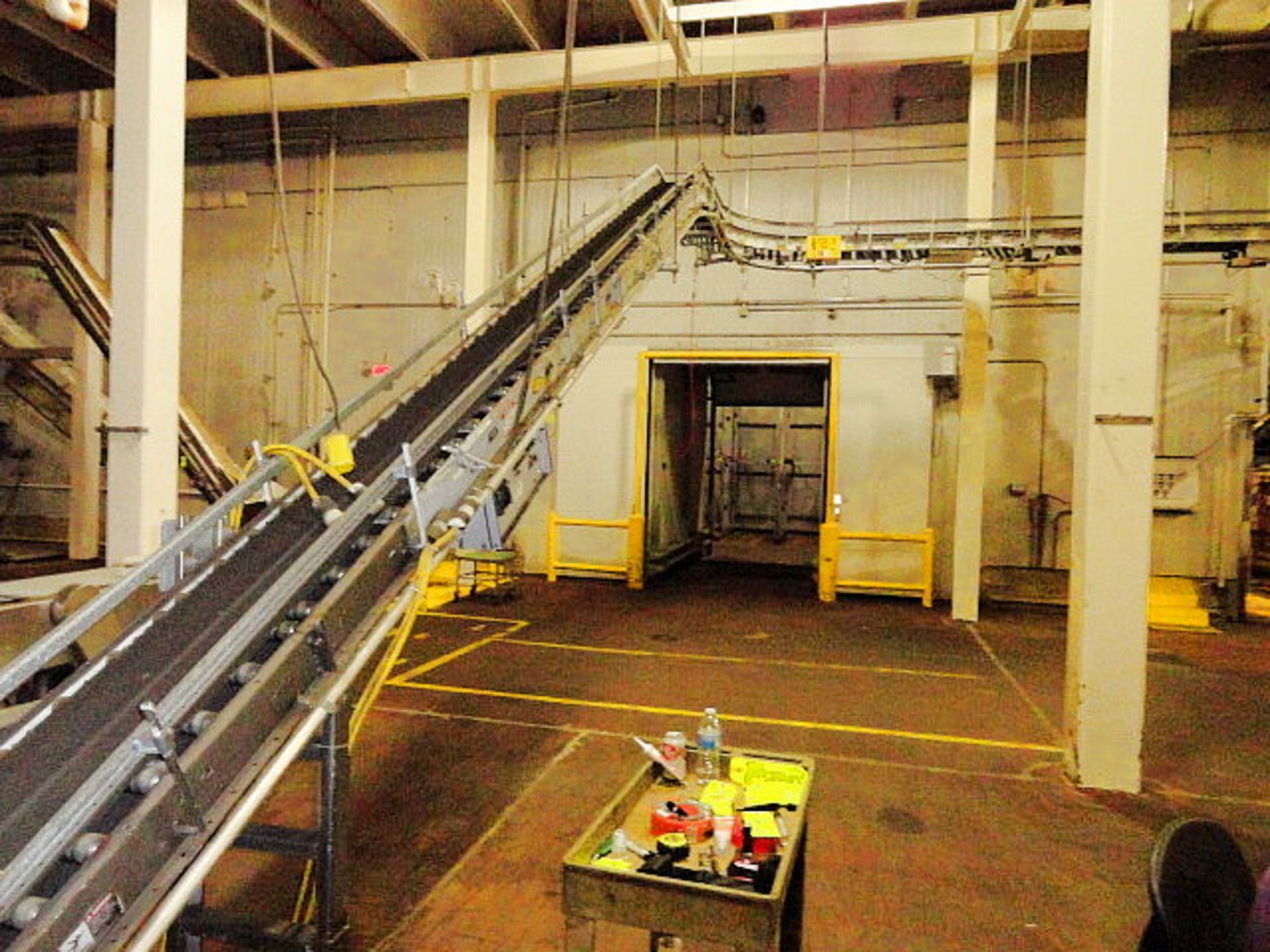 Hytrol Powered belt conveyor, 12" w x 100'+ suspended conveyor with (2) 90º turns, ($300.00 Required