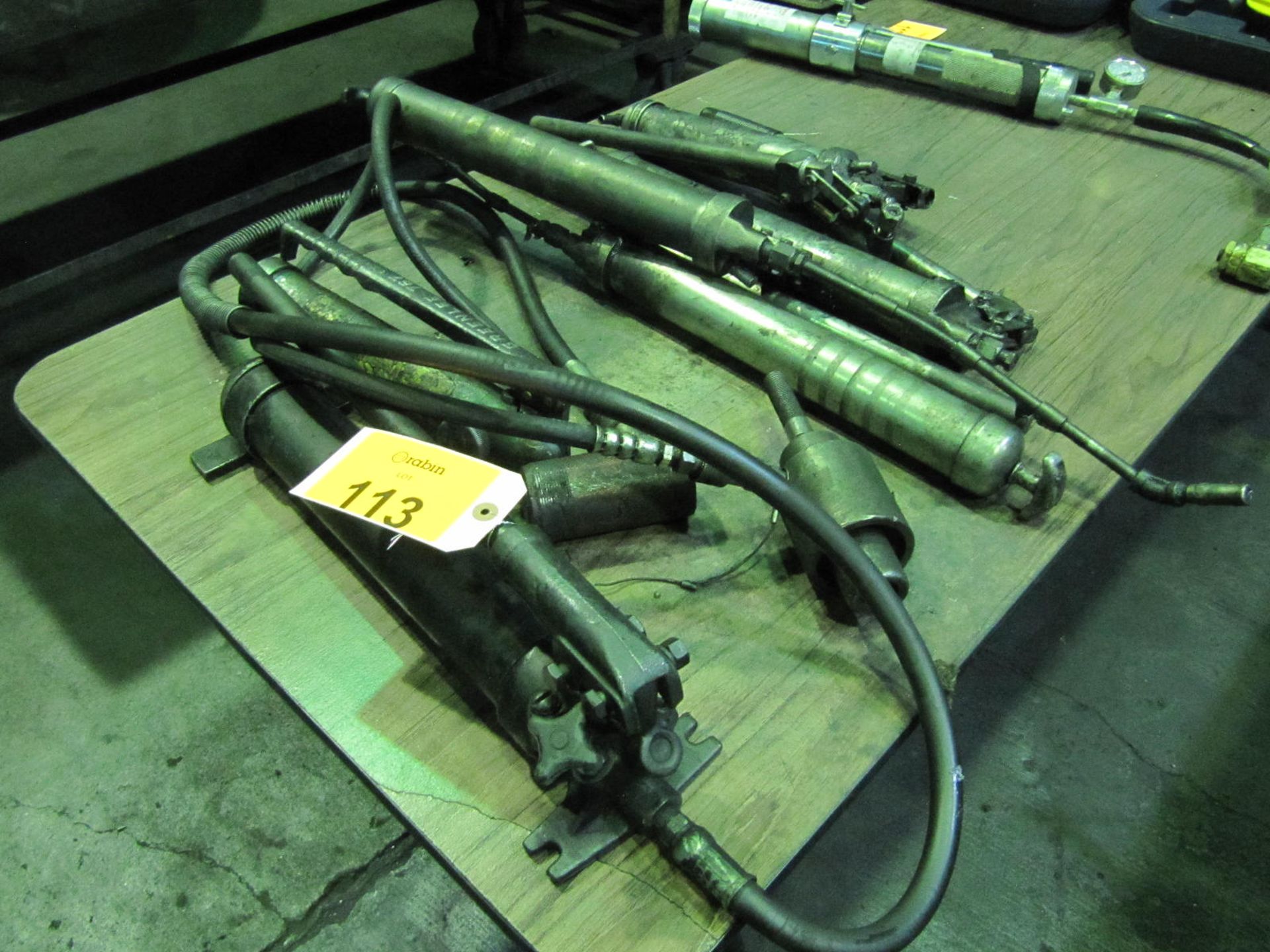 Lot of (4) assorted manual grease guns and (1) hydraulic power pack