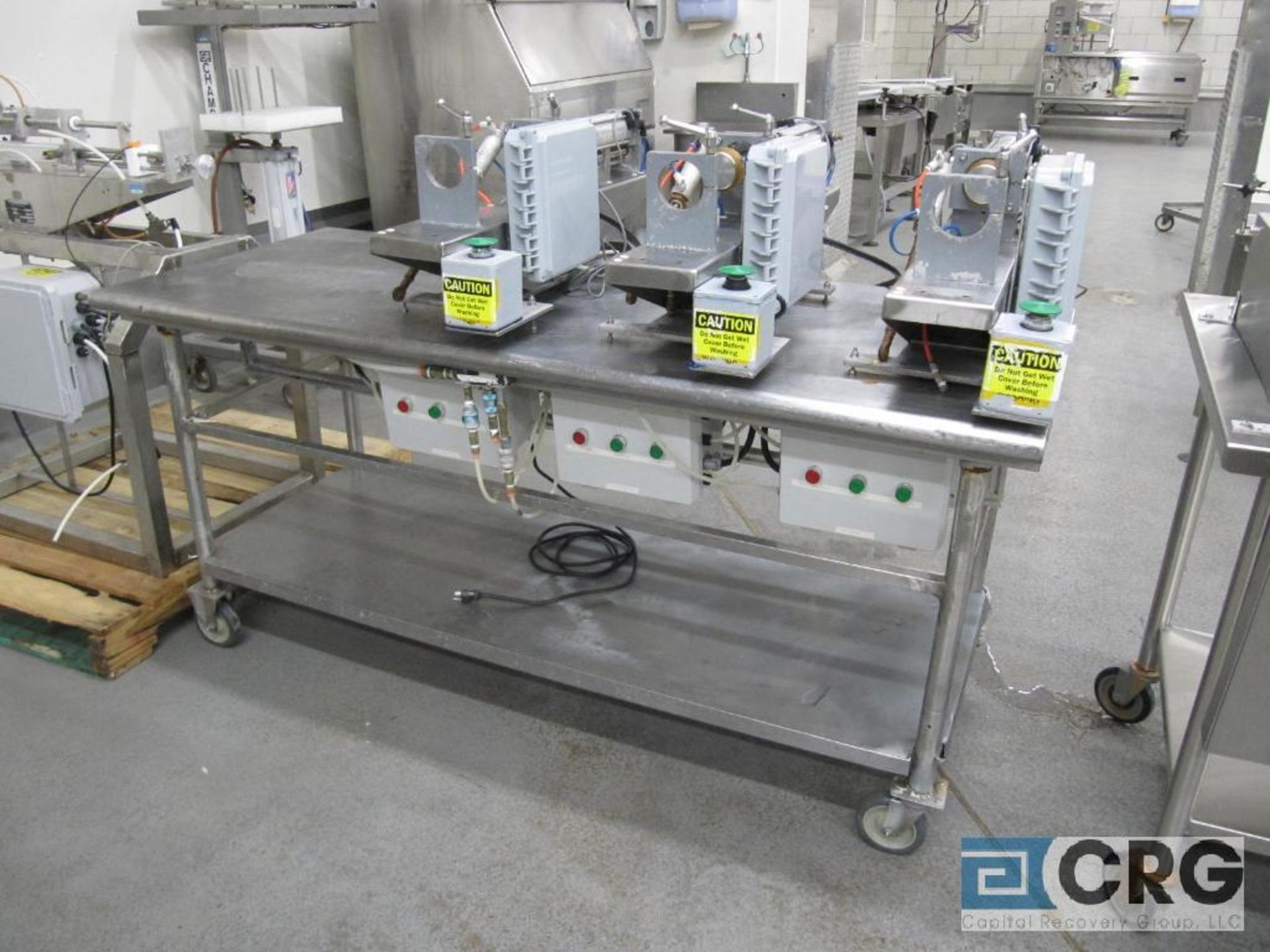 lot consisting of: (3) 2 1/2" dia. Single piston fillers, Mounted on stainless mobil table