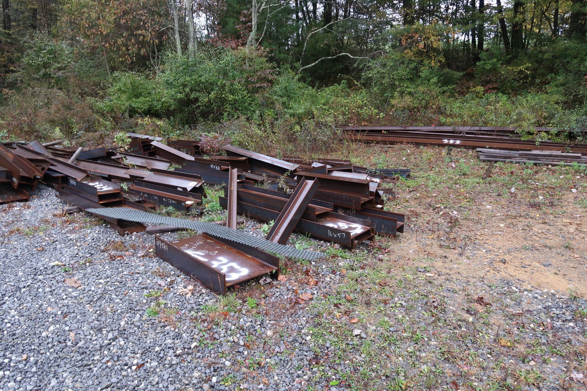 (LOT) LARGE QUANTITY OF ASSORTED STEEL STRUCTURAL ON GROUND AT OUTER PERIMETER OF DRIVE WAY - SEE