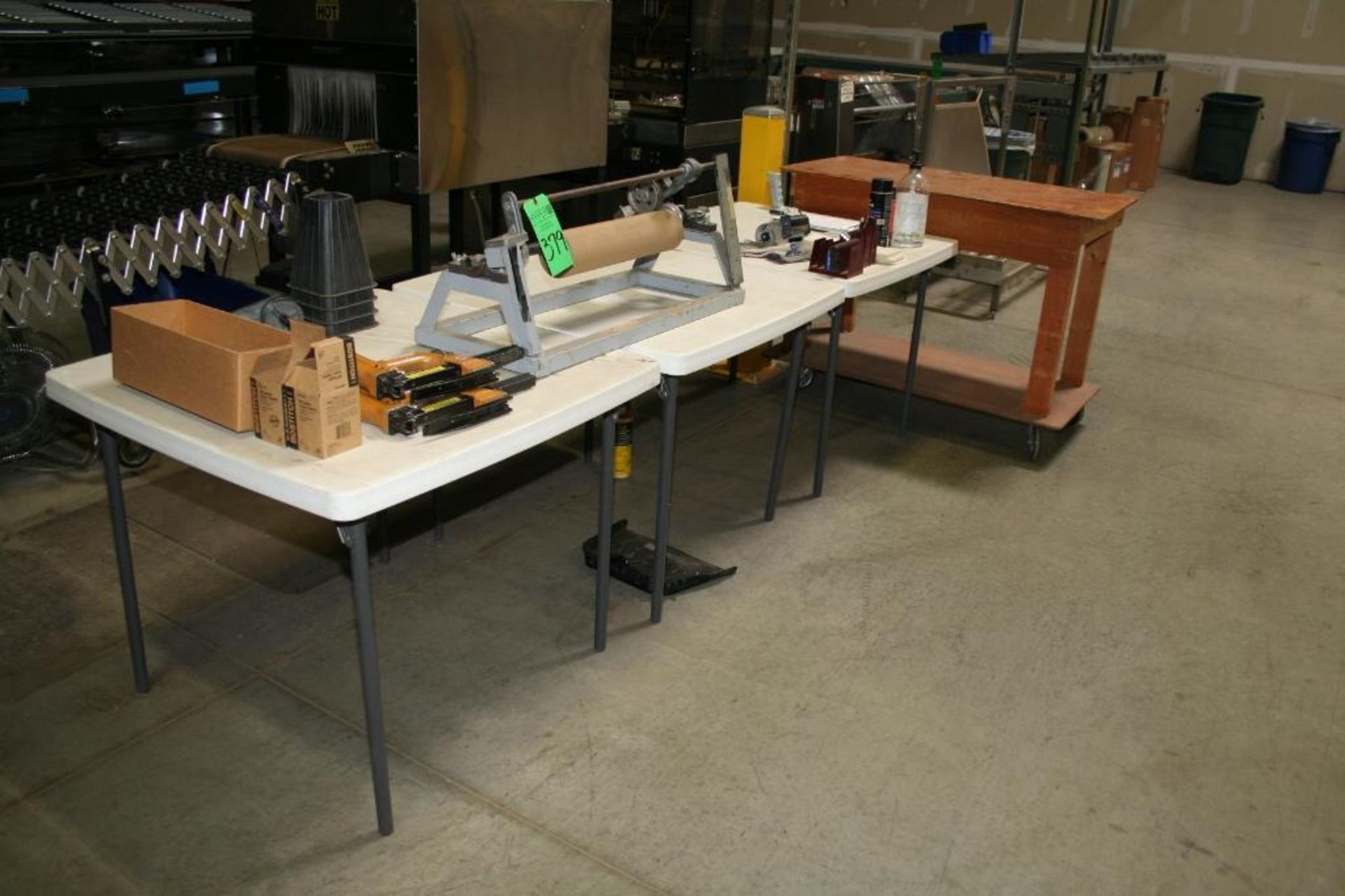(3) Folding Tables 3'x3', (1) Wood Rolling Cart 2'x4', (2) Air Staplers, 24" Roll Measurer, and Misc