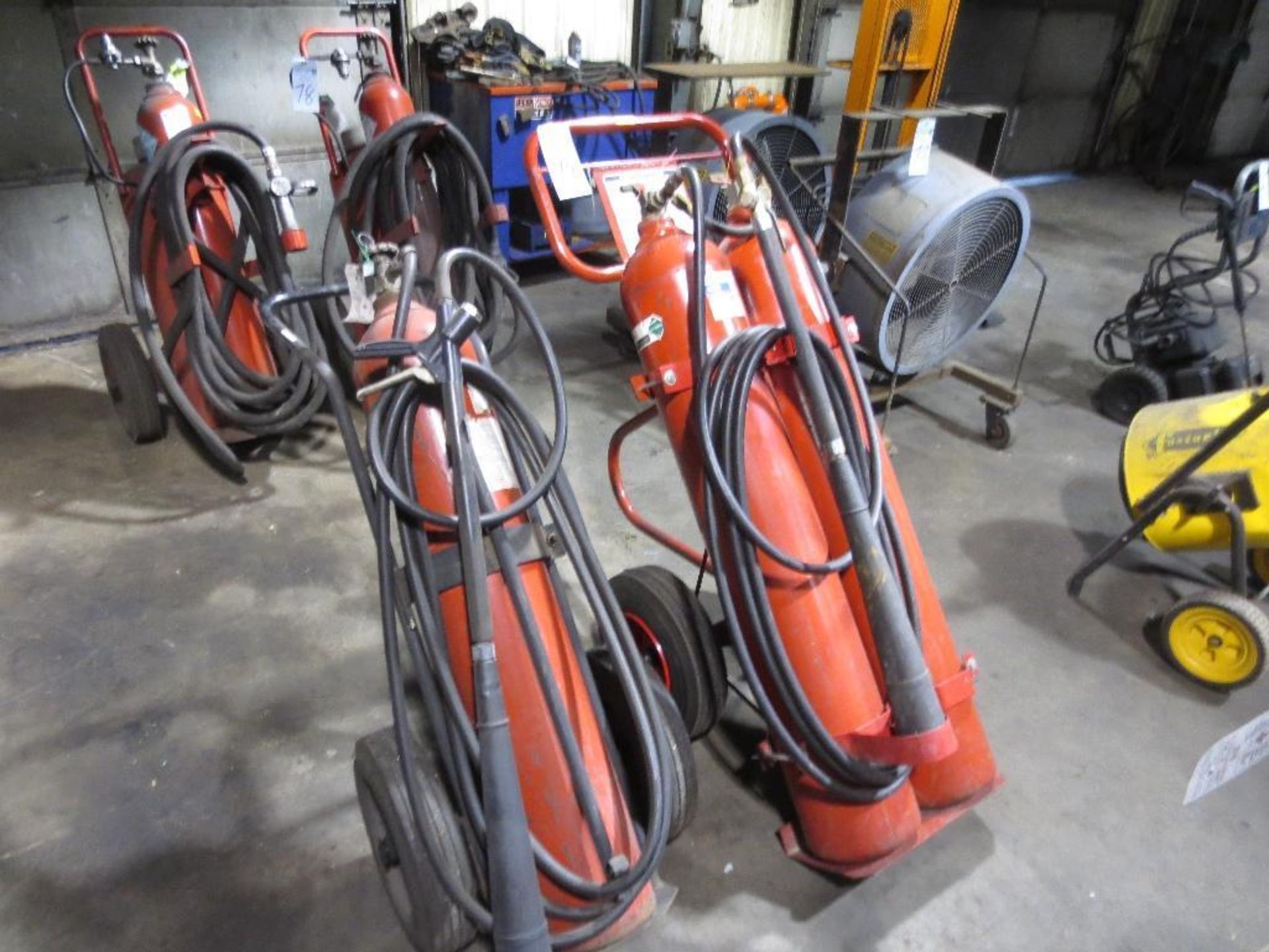 Two Extinguisher Carts, One with Two Carbon Dioxide Tanks and One with a Single Carbon Dioxide Tank