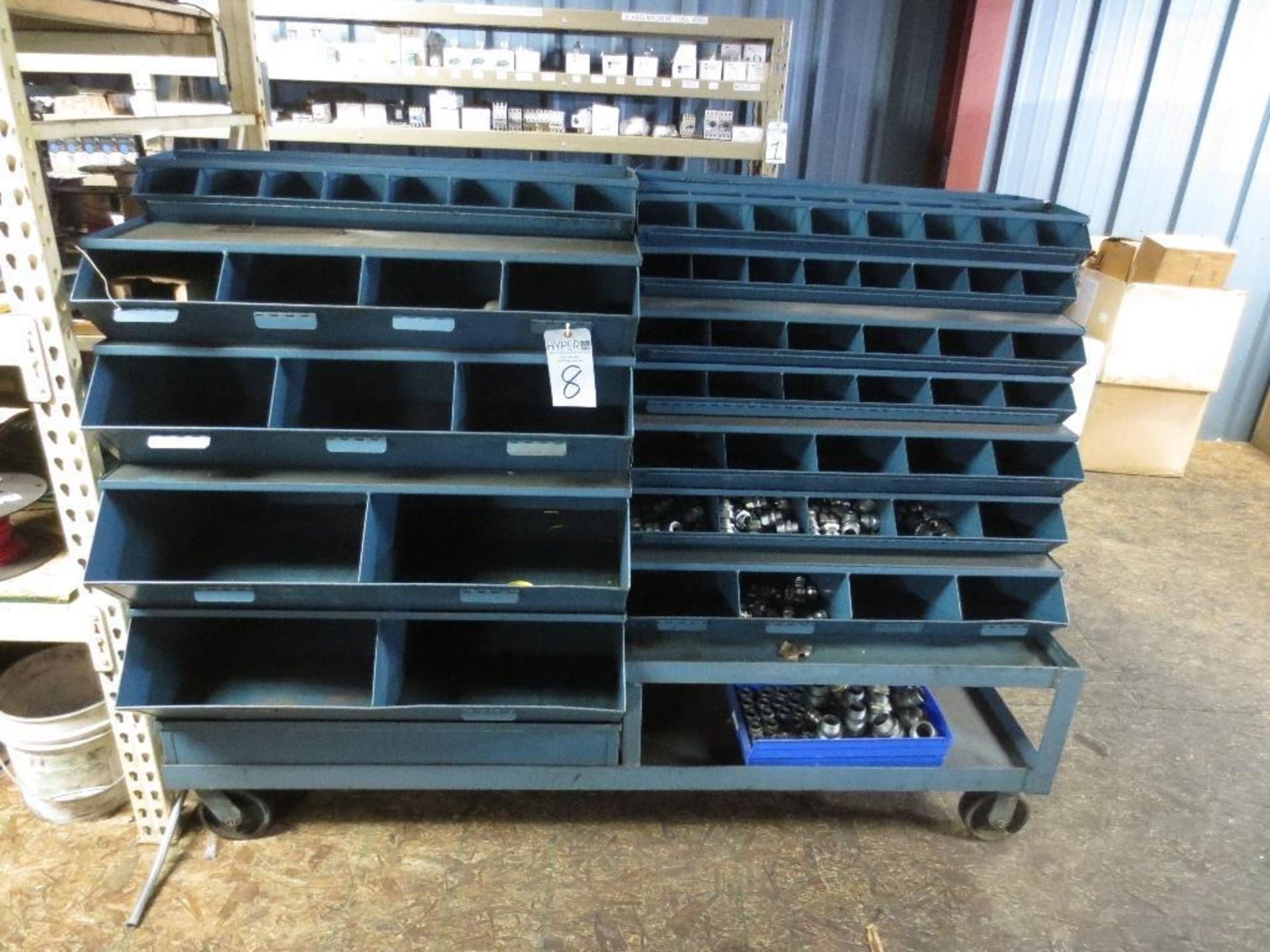 Double sided parts bin cart with small amount of contents.