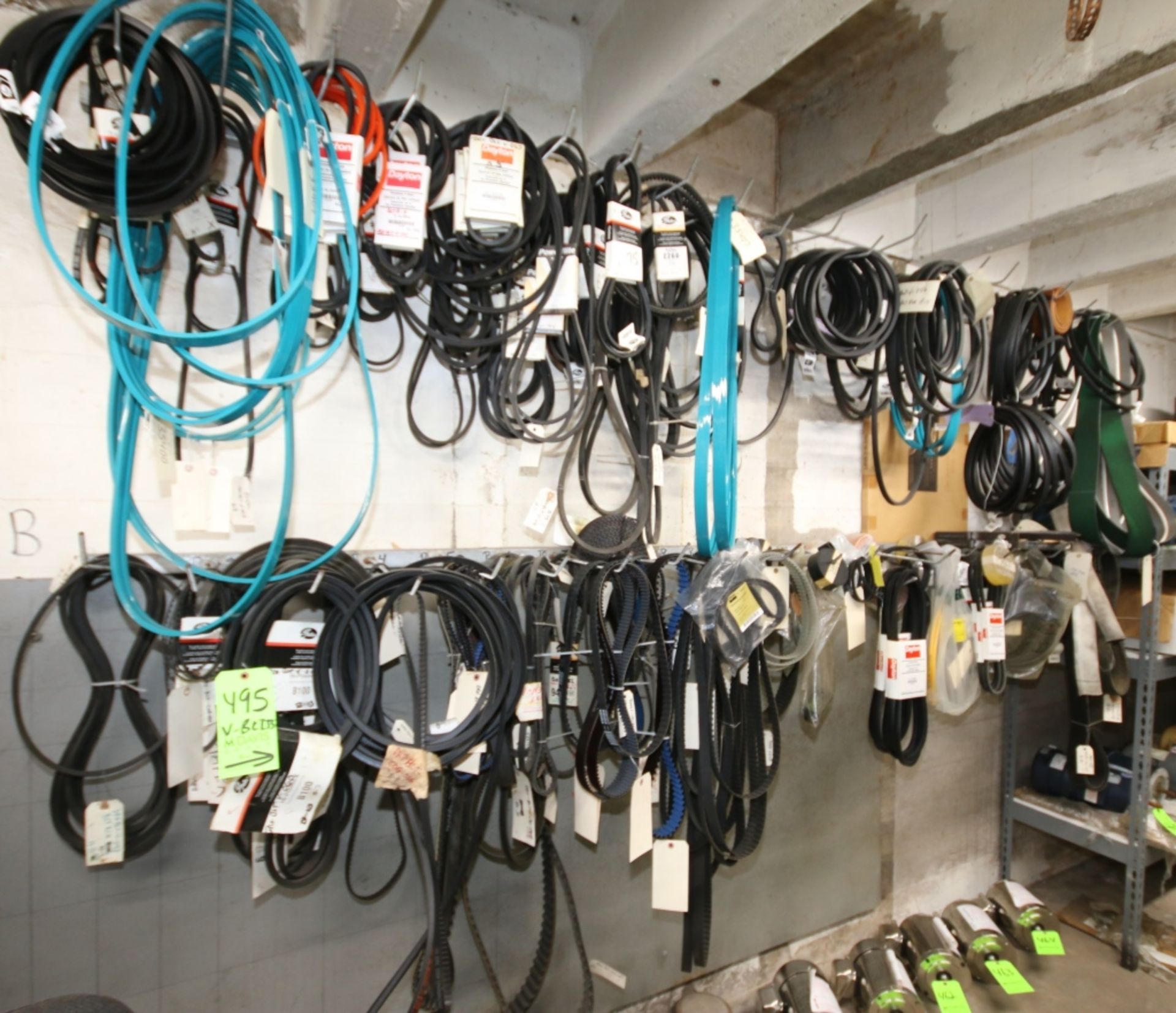 Lot of Assorted Machinery Belts on Wall