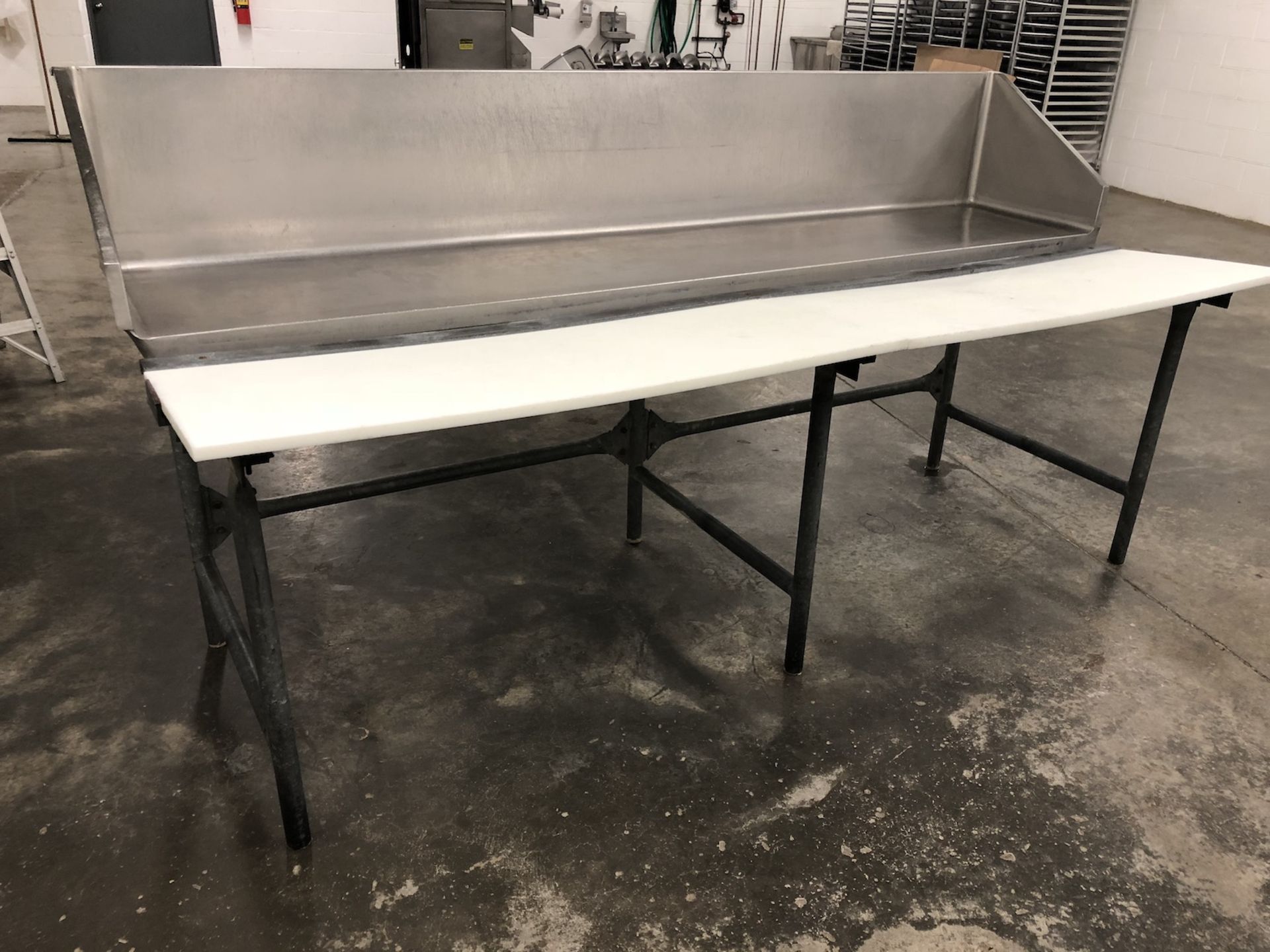 S/S Butcher table with stainless steel back panel and plastic butcher blocks approximately 8’ Long