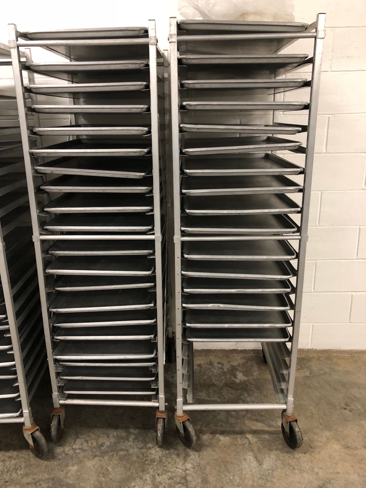 (2) Channel Approximately 64” Tall Tray Racks, Mounted on Casters, 20 Tray Capacity