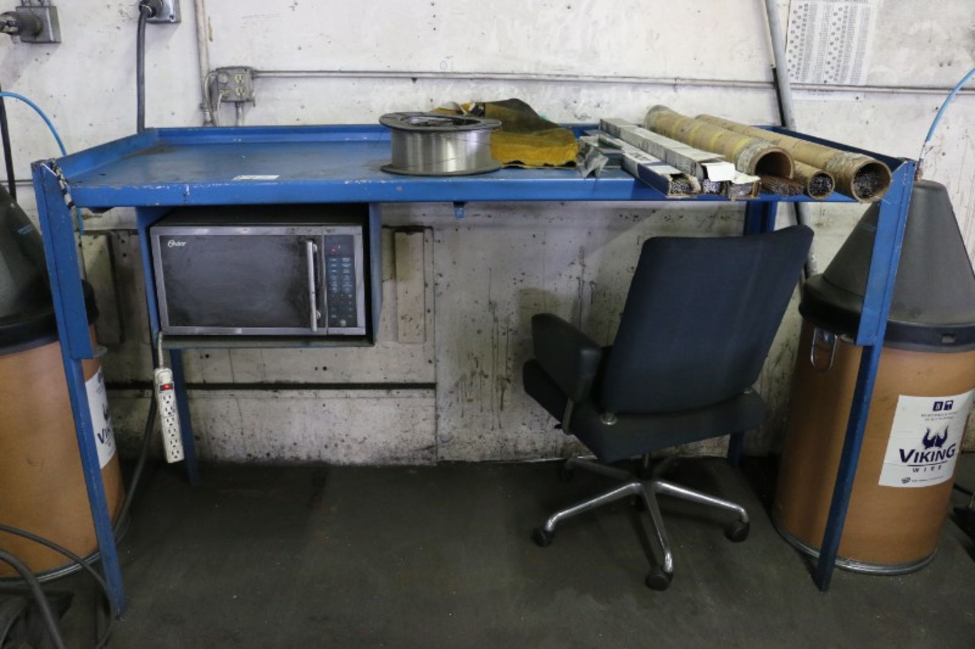 Work Bench with Assorted Welding Wire, Rods, and Microwave