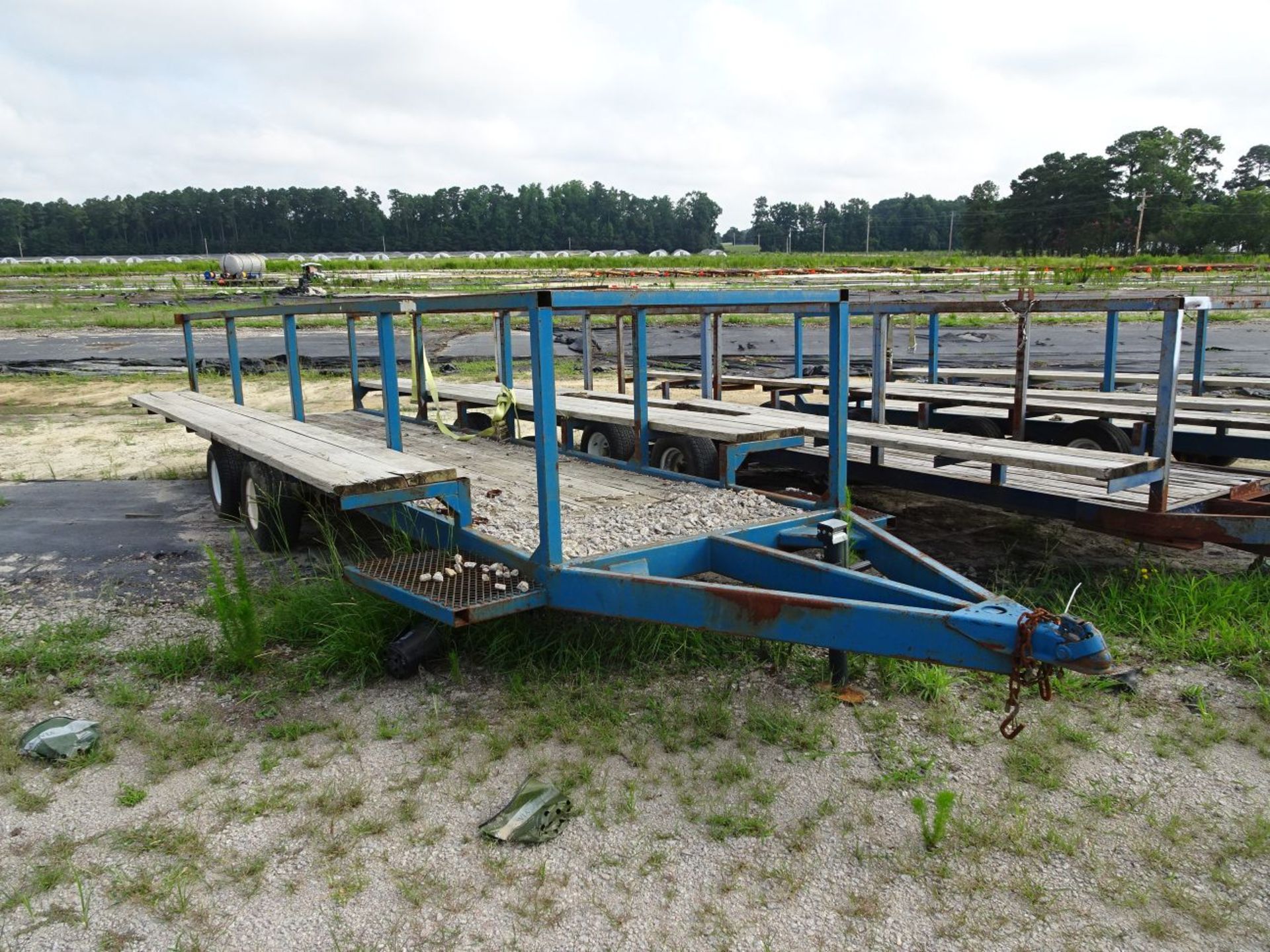 FARM BUILT CUSTOM CART TRAILER, WOOD BED, HAS OUTSIDE MOUNTED WOOD BENCHES, 17' LONG, TANDEM AXLE,