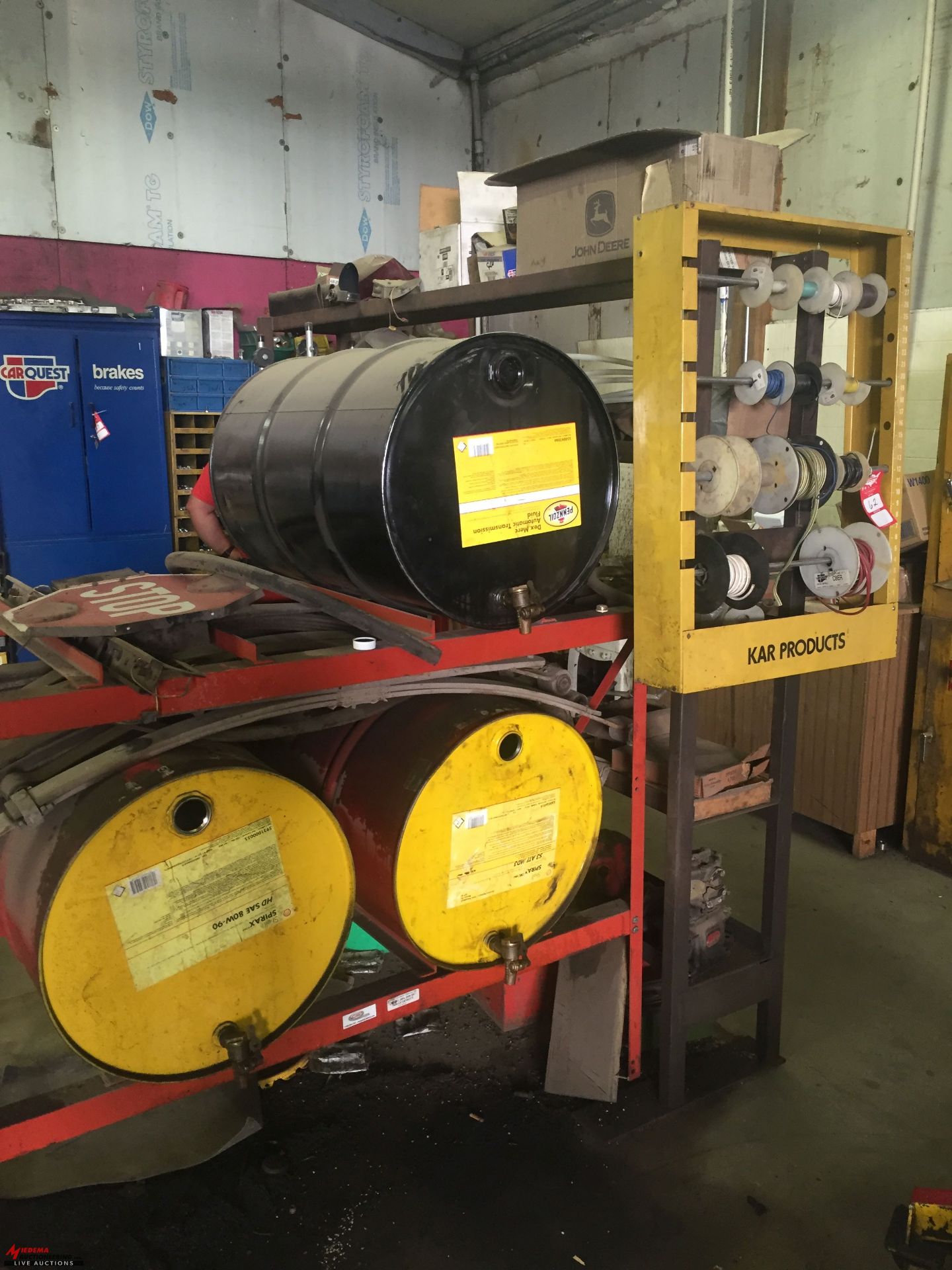 BARREL RACK WITH BARRELS, WIRE HOLDER WITH ASSORTED WIRE, ASSORTED PARTS ON METAL RACK, FLAMMABLE