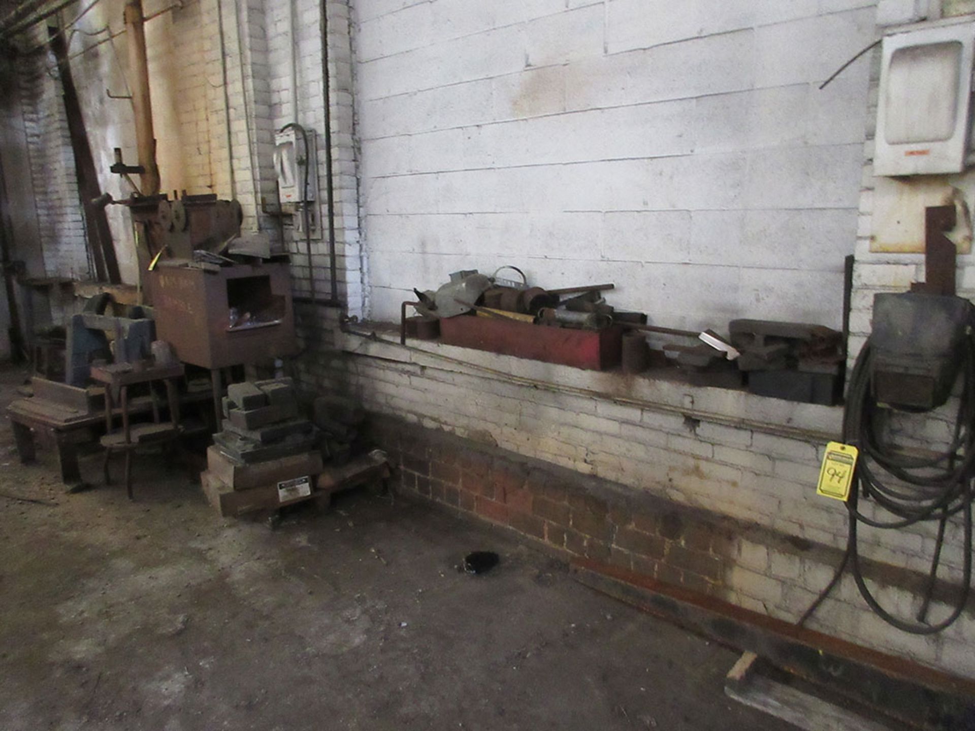 FURNACE, ITEMS ALONG WALL, CABINET WITH WELDING ROD, AND TABLE WITH C-CLAMPS