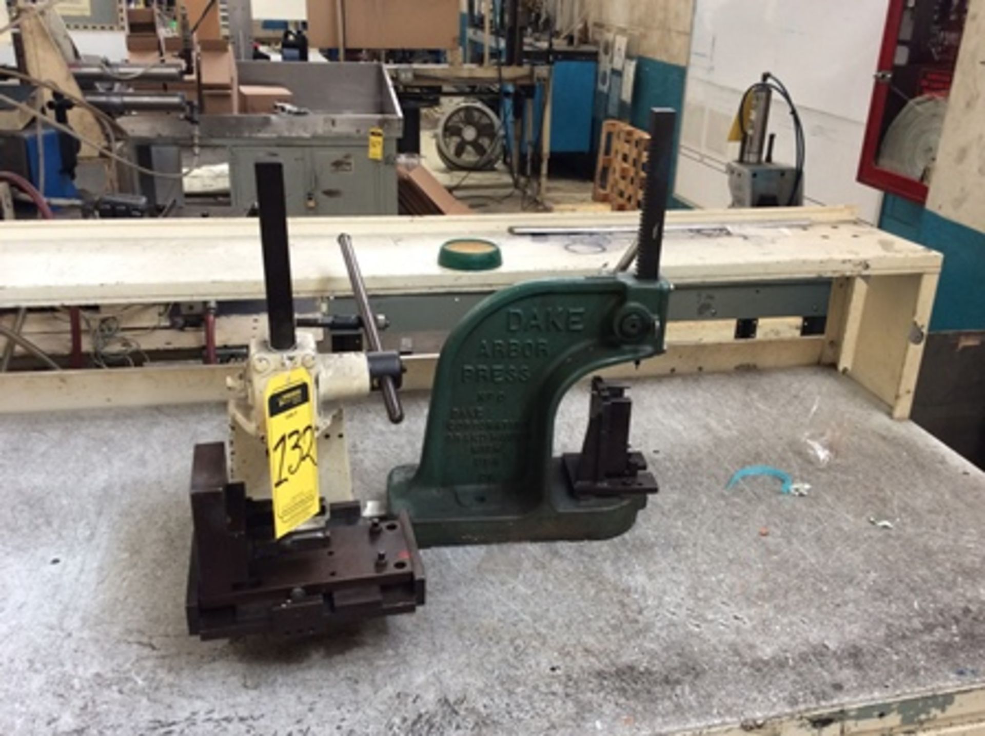 Work table with nylamid cover, 2 Dake manual presses and pedal stapler … - Image 4 of 8