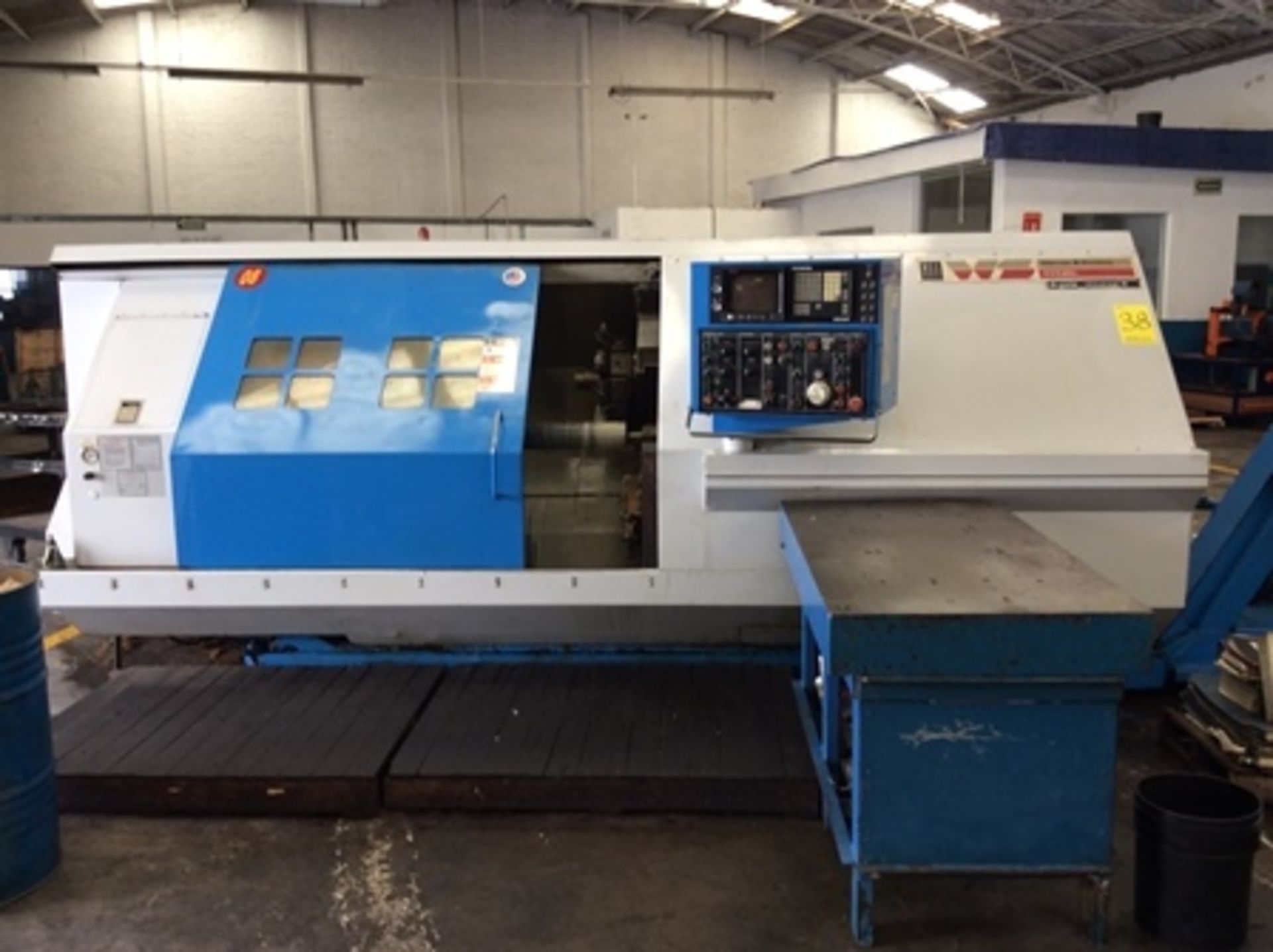 Torno CNC marca Warner & Swasey mod. Titan con torreta de 12 portaherramientas, volteo de 10" de di