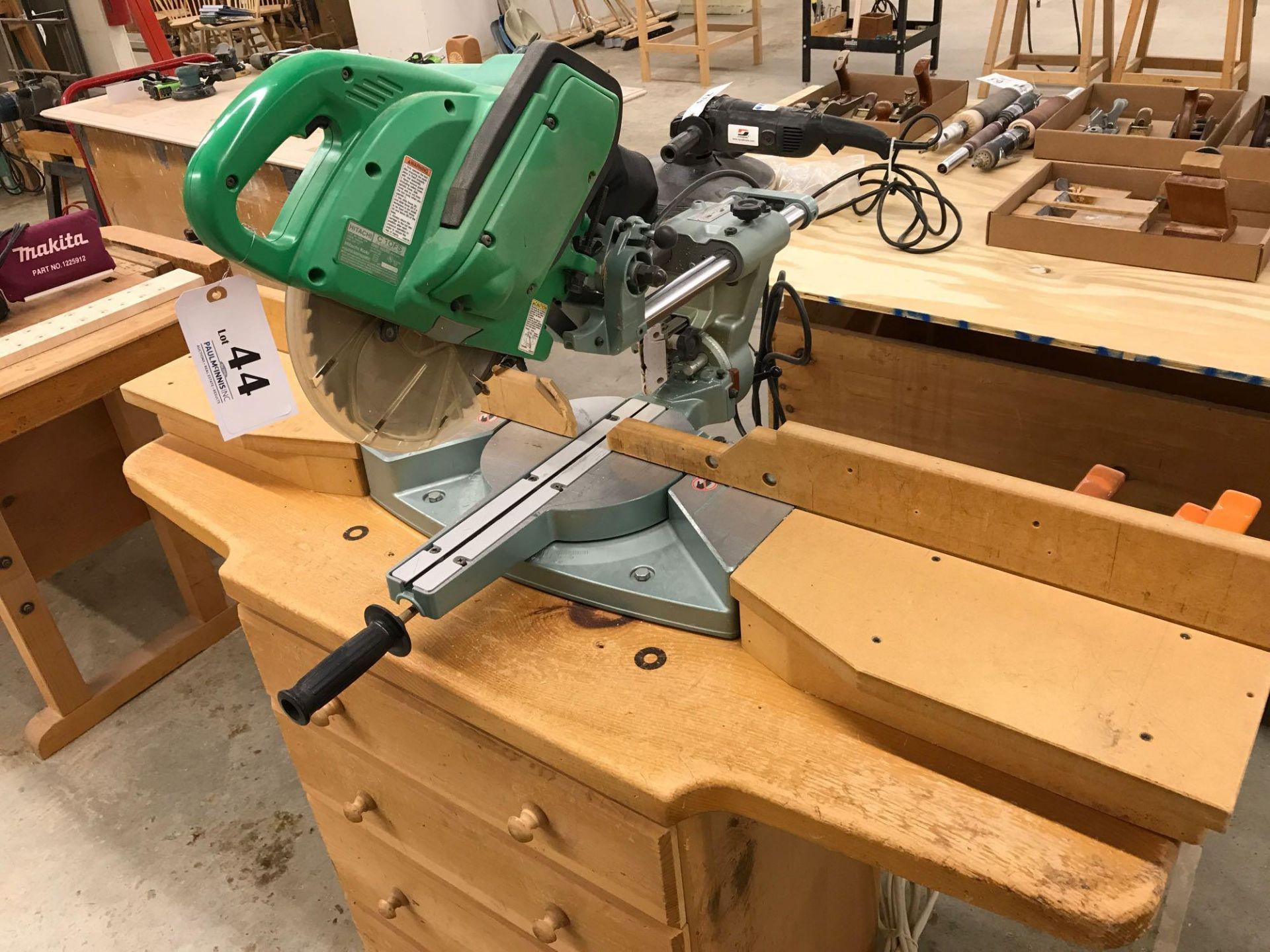 Hitachi sliding miter saw. Model # C1ofs with four-drawer cabinet with contents