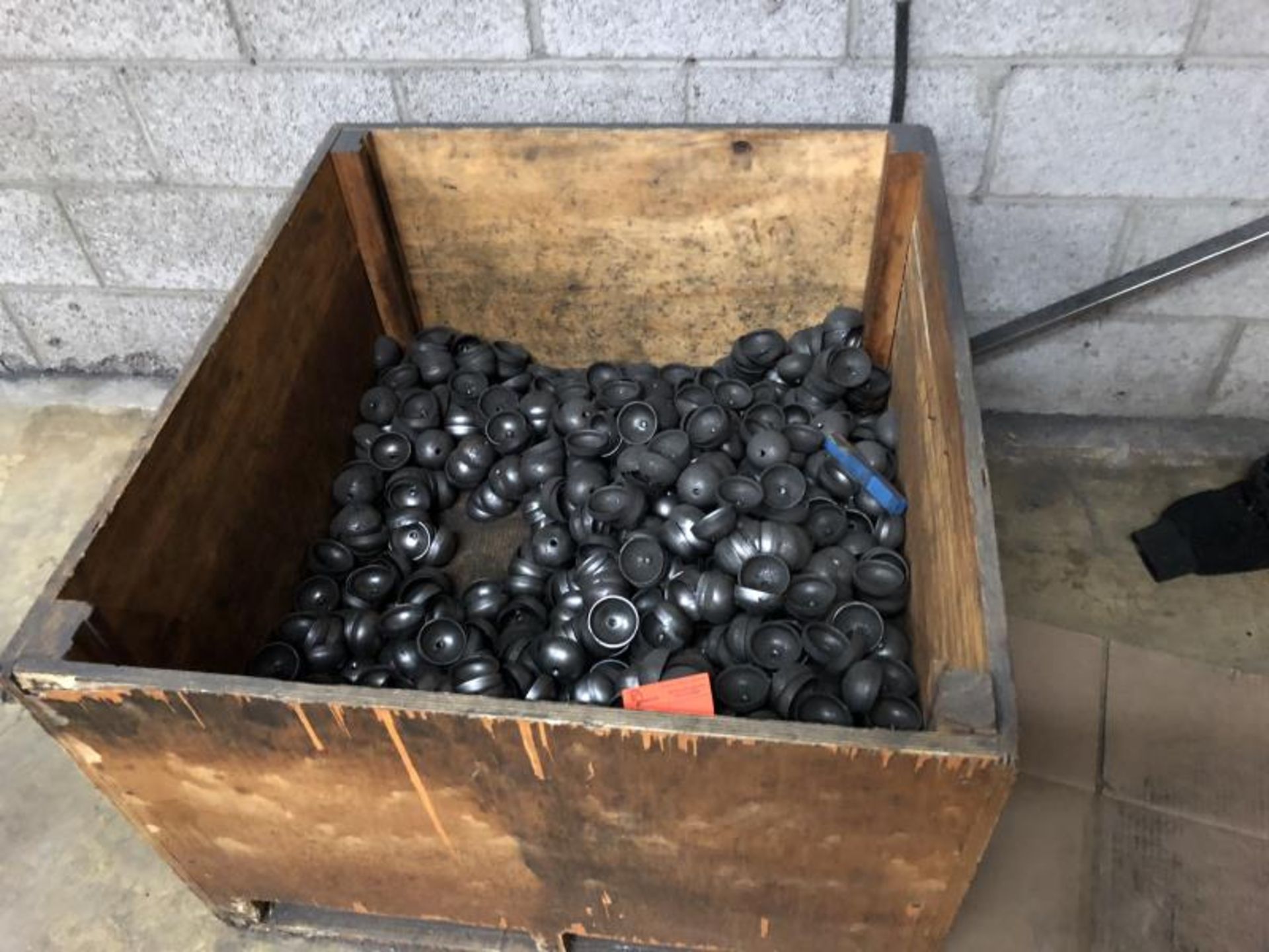 Wooden Crate of rounded threaded caps