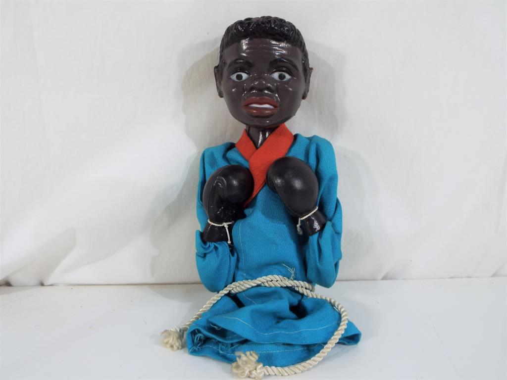 A mechanical glove puppet in the style of a boxer,