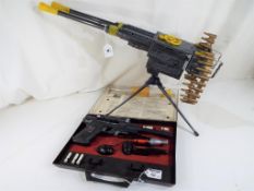 A tin-plate battery operated machine gun on tripod stand by Mo Dean Toys, with ammunition magazines,
