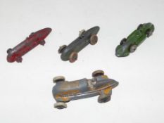 Four early 20th century metal diecast model racing cars, playworn,