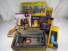 A box of G scale scenics to include street lamps, figures, telephone boxes,