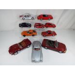 Diecast Models - ten diecast model motor vehicles displayed over two shelves to include Burago,