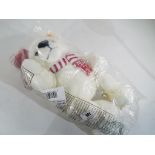 Steiff - a Steiff teddy bear (white) in mint condition wearing a hat and scarf, button in ear,