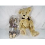 A mohair Steiff teddy bear wearing a 2006 medal, approximate height 34 cm,