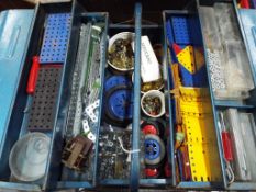 Meccano - a metal tool box containing a quantity of Meccano construction pieces to include plates,