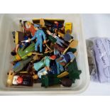 A box containing a collection of G scale figures and other scenics