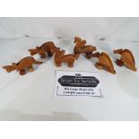 Approximately sixty wooden push along toys in the form of dinosaurs,