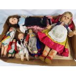 Six early to mid 20th century dolls dressed in period costume,