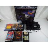 Sega - A boxed Sega Mega Drive console with six game cartridges including Altered Beast,