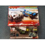 A boxed Micro Scalextric 1:64 scale Off Road Mayhem set and a radio controlled Missile Launcher (2)