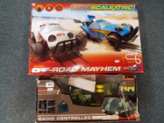 A boxed Micro Scalextric 1:64 scale Off Road Mayhem set and a radio controlled Missile Launcher (2)