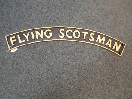 A cast iron sign entitled The Flying Scotsman, 11 cm (h) x 90 cm (w).