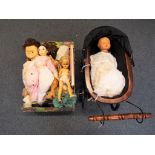 Dolls - a quantity of vintage dolls to include a Pedigree doll and a decorative doll's pram (2)