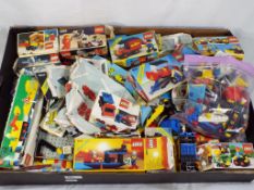 Lego - a tray of boxed and unboxed Lego building bricks with some empty original boxes,
