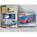 Two boxed cars, one a radio controlled Lamborghini Countach and the other a Burago Porsche 911,