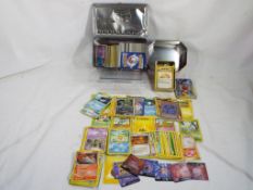 A collection of Pokemon trading cards in three tins,