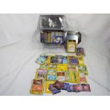 A collection of Pokemon trading cards in three tins,