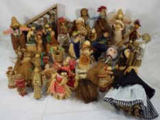 Approximately 45 dolls predominantly made of corn husk and some made of wicker,