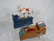 A tin-plate and plastic novelty money bank by Yone in the style of a Japanese house and garden,