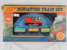 A battery powered miniature train set by Trans Pacific Ltd, set contains a steam loco,