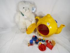Bluebird - a child's Big Yellow Teapot by Bluebird containing a car, a roundabout, figures,