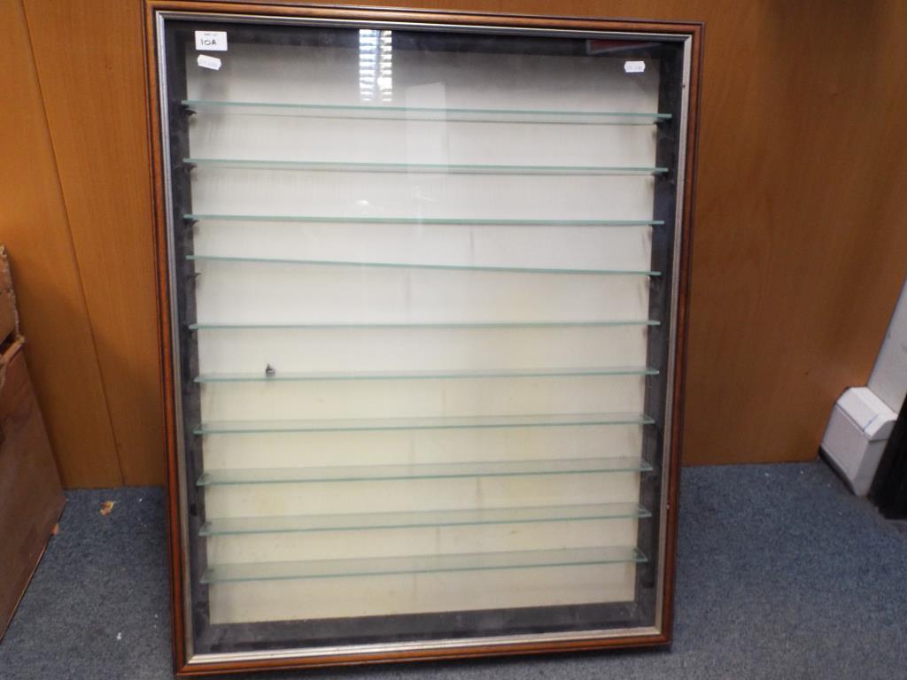 Side opening wooden display unit, with 10 glass shelves. Measures H83cm x W66cm x D13cm.