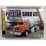 AMT - 1:25 scale model kit containing an International Paystar 5000 cement mixer box G items appear