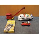 A lot to include a Tri-ang metal KL44 Jones crane, a Tri-ang milk lorry with 27 bottles,