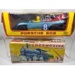 Two vintage tin plate vehicles comprising a Daiya tinplate battery operated Porsche 908 with sound