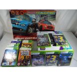 An X-Box 360 in original box together with twenty games and a Scalextric Racer set,