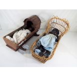 Dolls - A wooden cradle an wicker cradle containing two dolls,